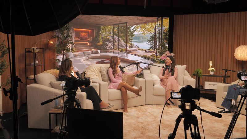 The Lounge studio — cozy couch setup with lake LED backdrop during a recording session