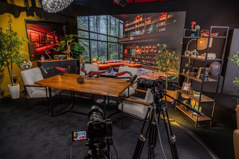 The Roundtable studio — podcast table with LED backdrop and professional cameras